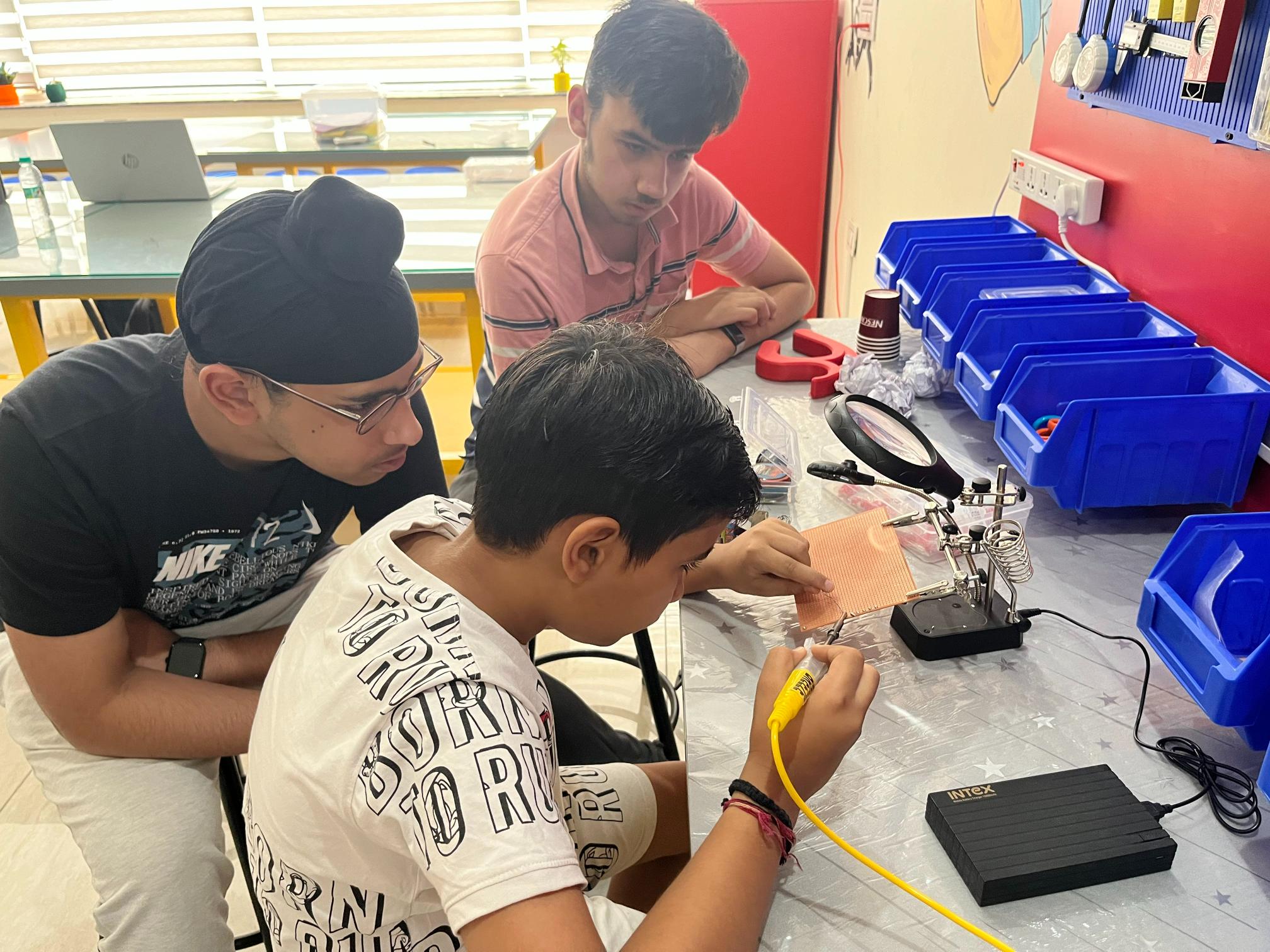 STEMorbit students collaborating on a robotics build